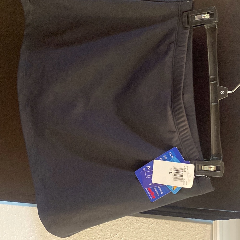 New Marika Black tennis skirt with built-in shorts. Size large,
